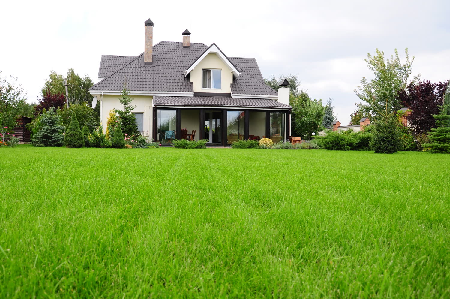A home behind a wide, even green lawn
